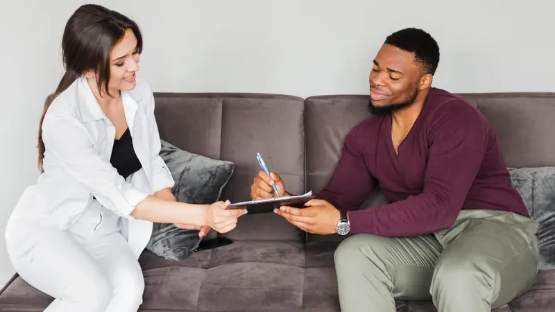 Provider and client discussing a personalized psychiatric treatment plan on a clipboard