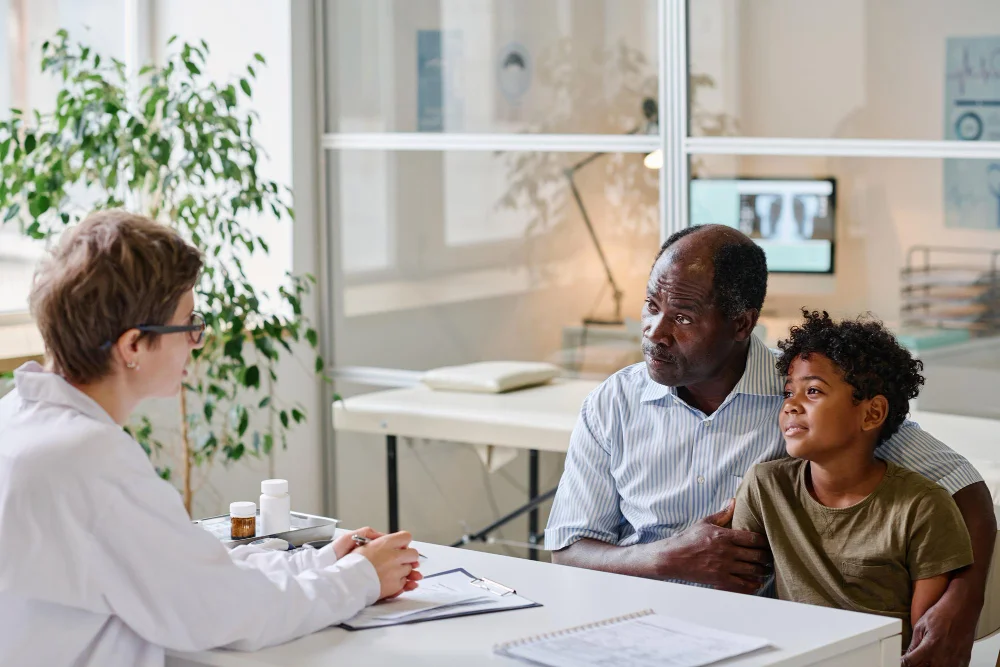 Psychiatrist discussing discharge planning with a father and young son at Bridges Community Support Services