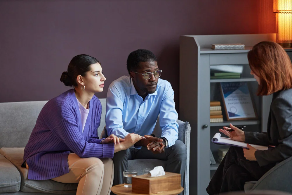 Couple speaking with a certified peer specialist during a counseling session at BCSS in Orlando FL