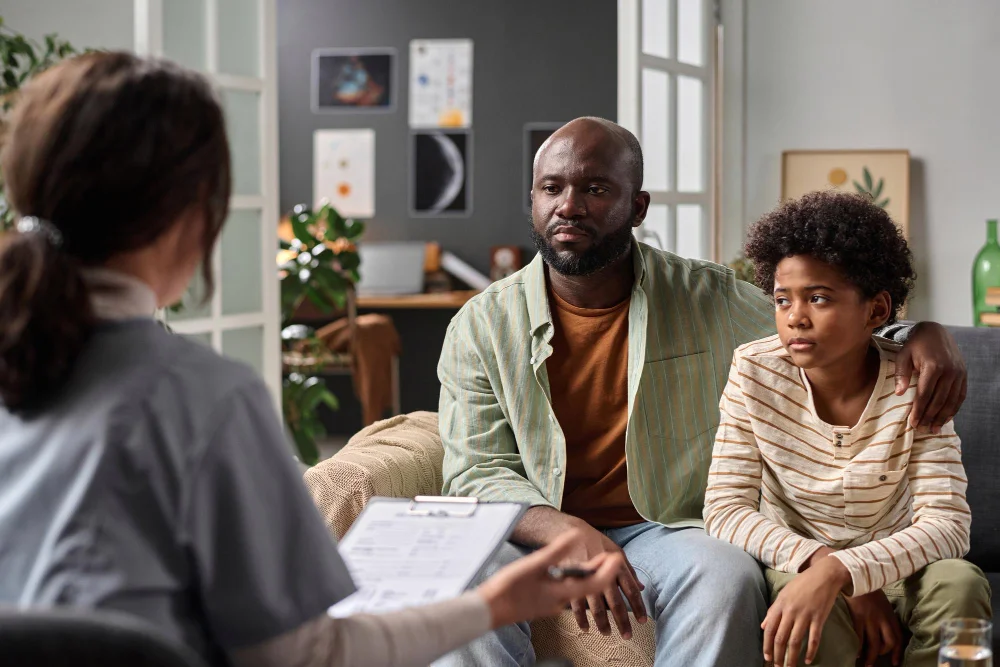 Father and child meeting with a compassionate family counselor in Orlando, FL